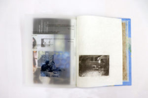 Handmade book showing a transparent page with text and images on it and another page with a black and white photograph. Through the transparent page, some other images on the next page are visible.